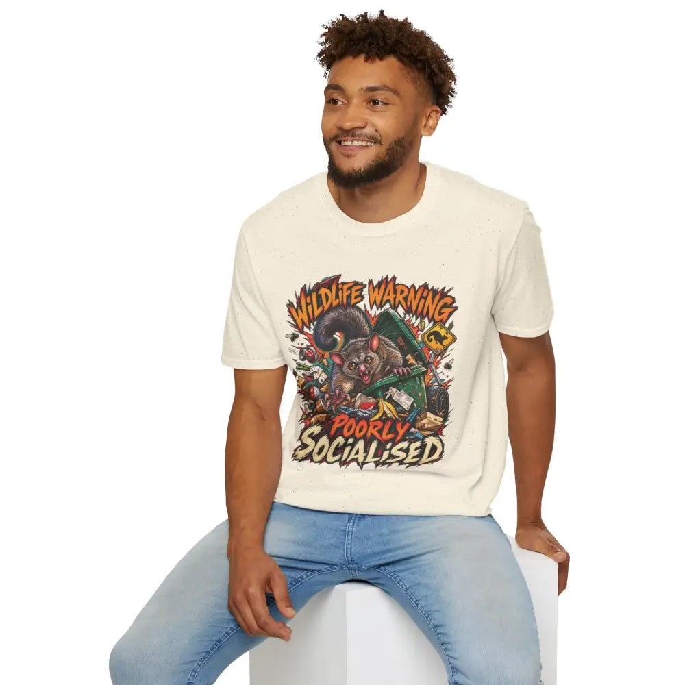 Cream-colored unisex ring-spun cotton t-shirt with wildlife warning cartoon possum design and low heat care instructions