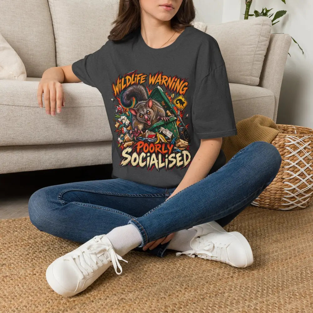 Dark gray oversized unisex t-shirt with vibrant cartoon possum graphic wildlife warning poorly socialised made of ring spun cotton with low heat care instructions