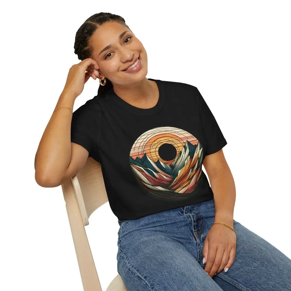 Young woman with braided hair wearing a black softstyle t-shirt designed to reduce fabric waste and featuring an elastic ribbed collar, showcasing mountain and sunset graphic