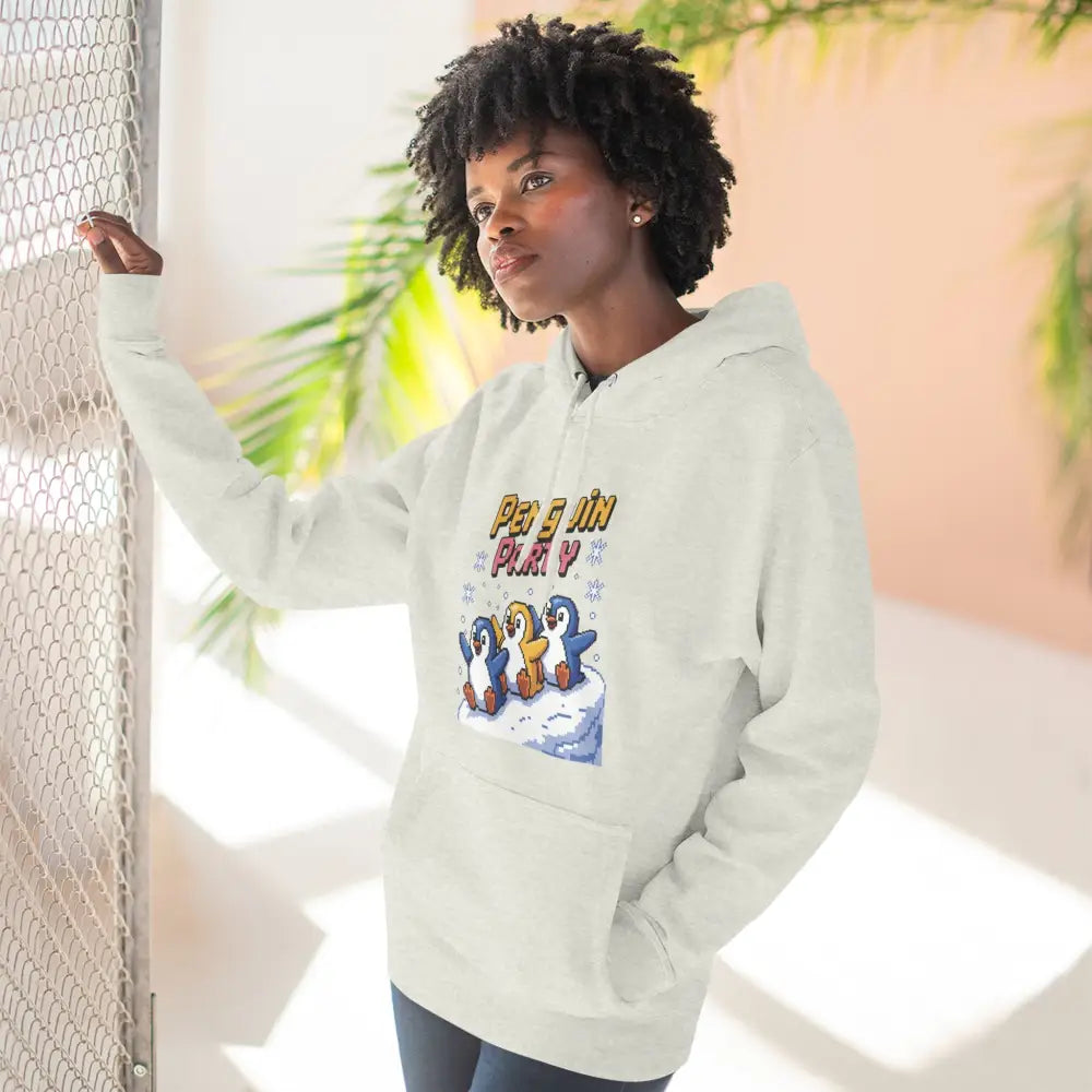 Woman wearing cream-colored cozy fleece hoodie with Penguin Party graphic, machine wash friendly