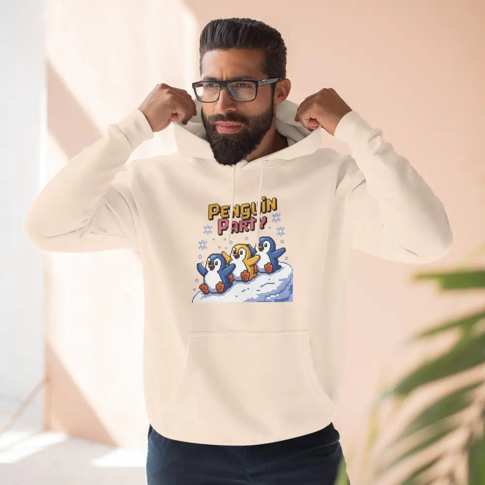 Men’s cream-colored hoodie with Penguin Party graphic in cozy fleece, machine washable, low heat safe